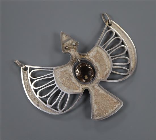 A stylish white metal and smoky quartz set drop bird pendant, signed en verso Guayashamin, width 98mm, gross 37 grams.